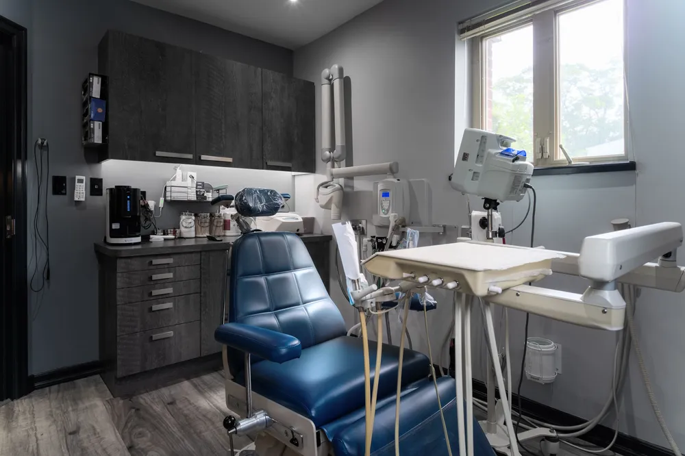 Bright treatment room with natural light and a reclining patient chair