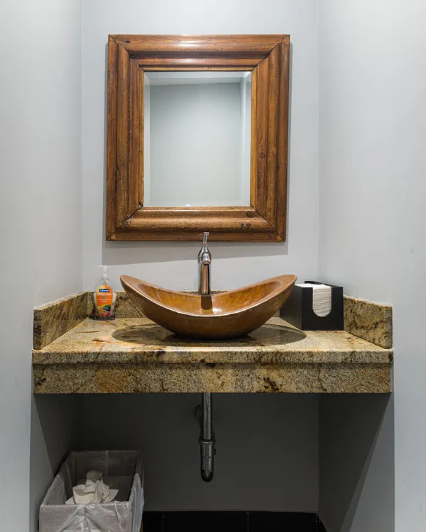 Patient restroom with vessel sink and framed mirror